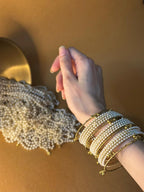 Pearl bangles with gold ghungroo bundle