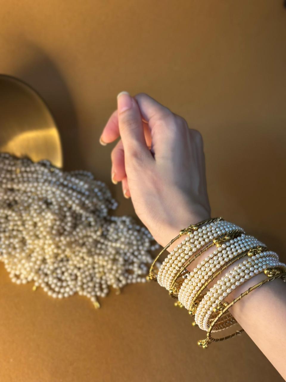 Pearl bangles with gold ghungroo bundle