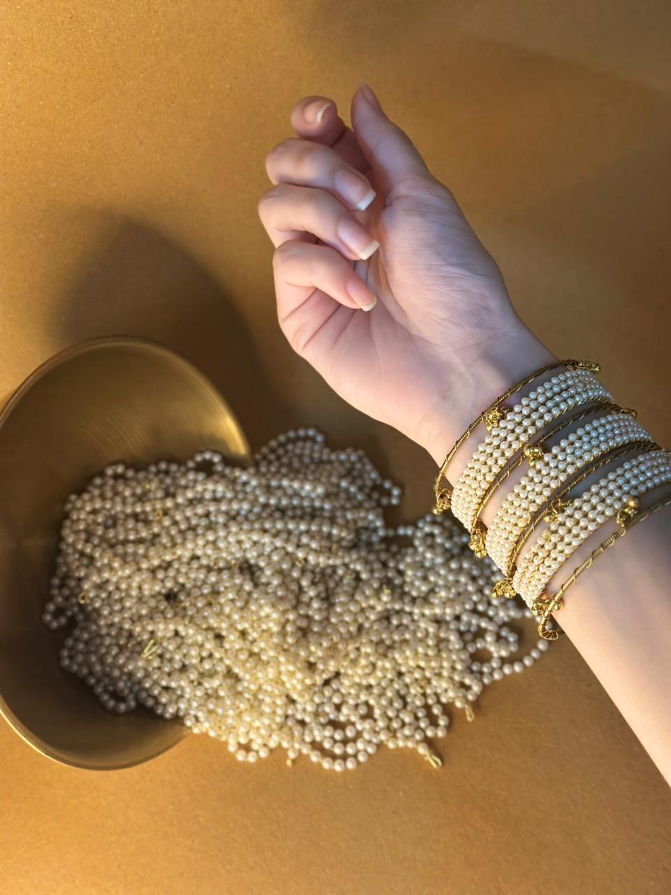 Pearl bangles with gold ghungroo bundle