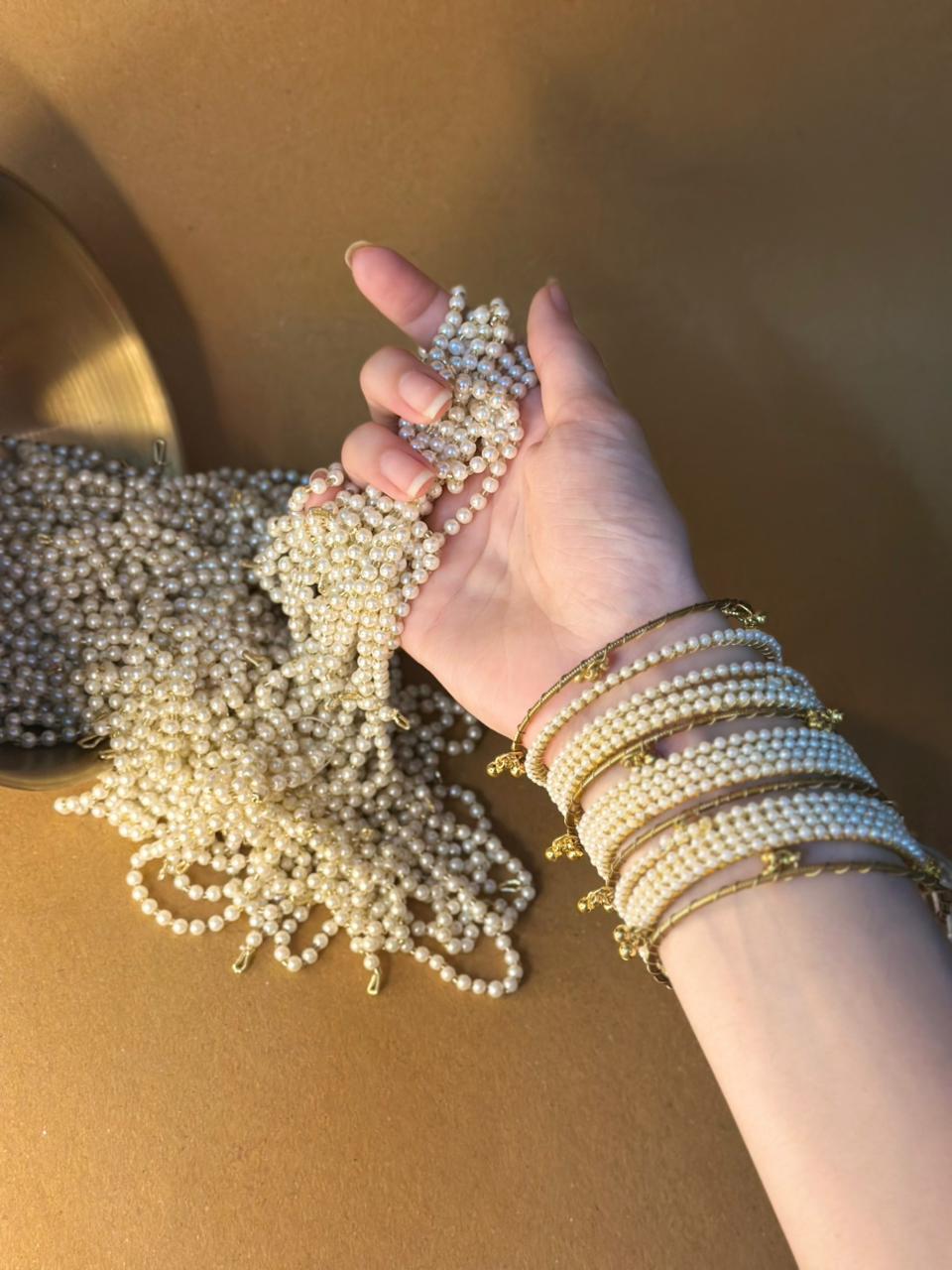 Pearl bangles with gold ghungroo bundle